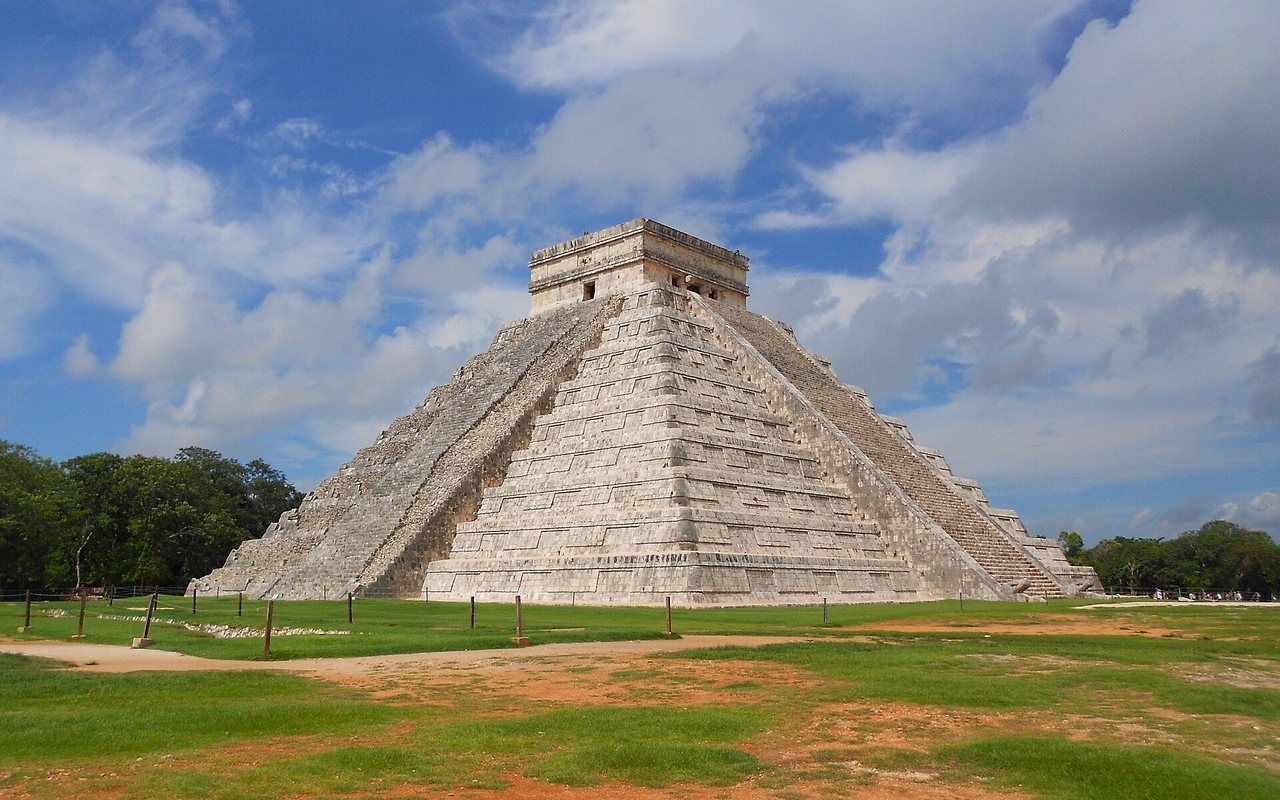 A large stepped stone pyramid with stairways on all four sides